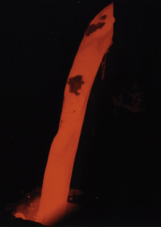 A turbulent pour stream with solid inclusions and thermal gradients.